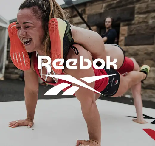 reebok logo on an image of a woman doing a plank on another woman